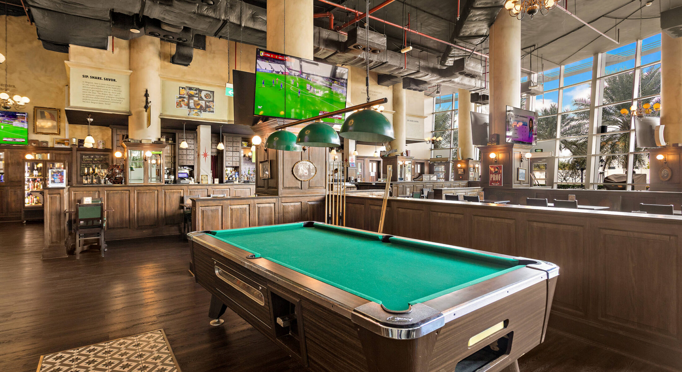 Interior of Belgian beer bar in Abu Dhabi with billiard table and seating