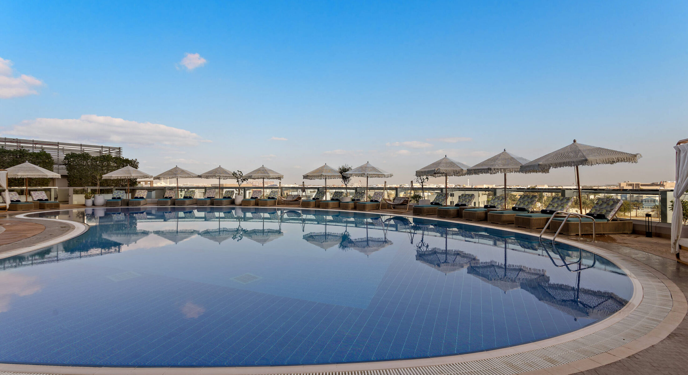 Outdoor swimming pool at Al Nasseem pool bar in Abu Dhabi overlooking the canal