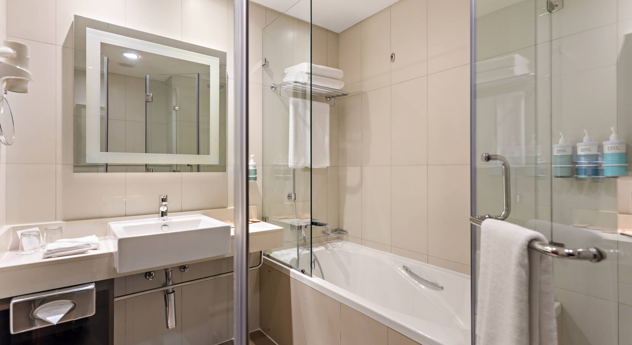 Modern bathroom in one-bedroom apartment near Grand Mosque Abu Dhabi with bath and shower