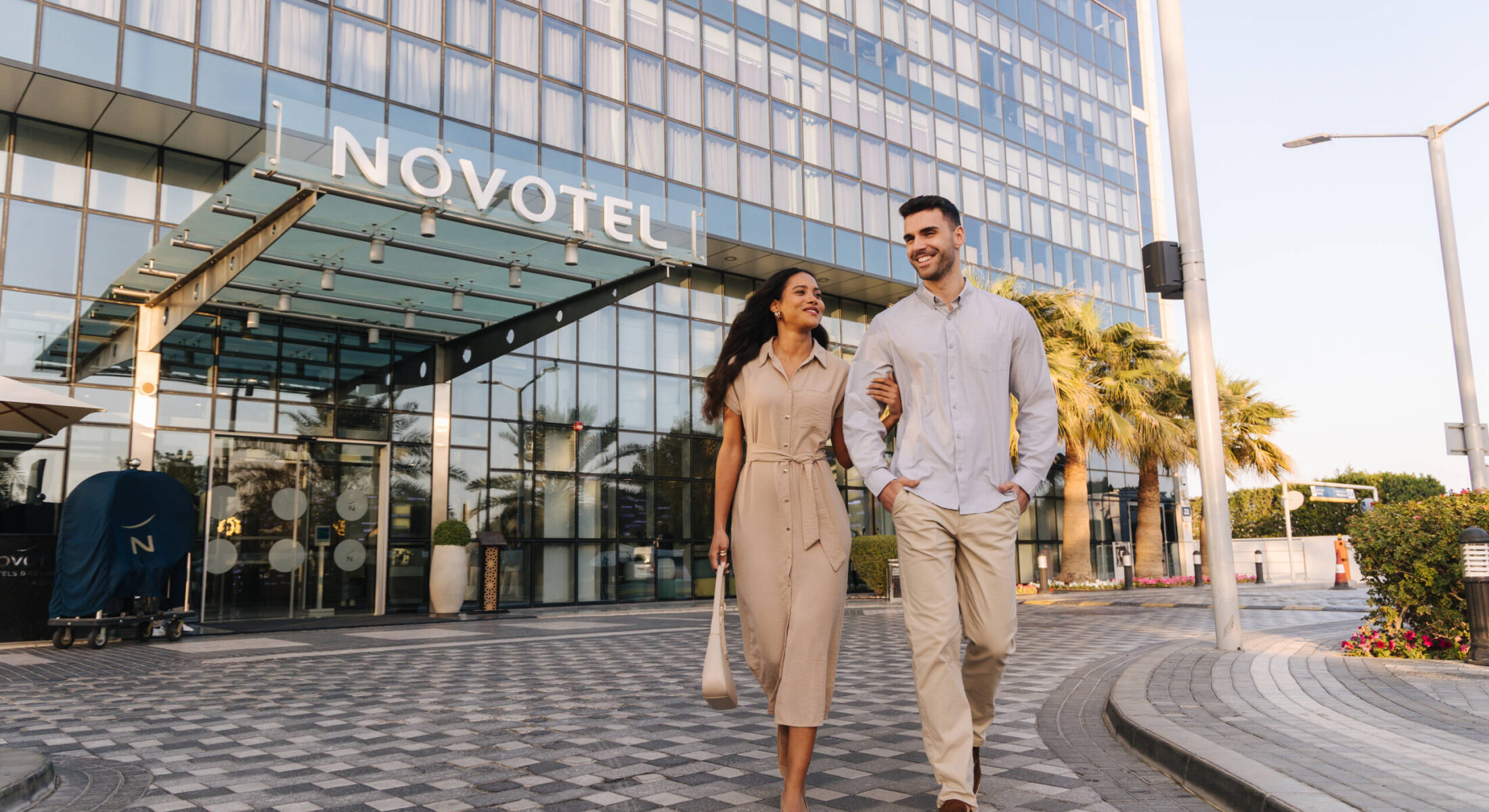Couple walking outside Novotel Gate Abu Dhabi 4-star hotel near Yas Island